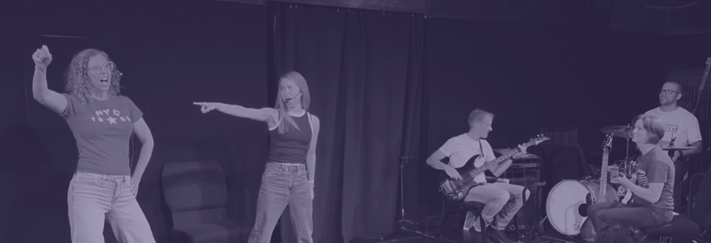 Mixtape performing live — singers, guitarist, bassist and drummer on stage
